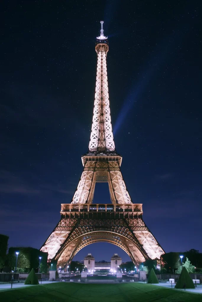 Beautiful view of the Eiffel tower in Paris at night with a lot of lights.